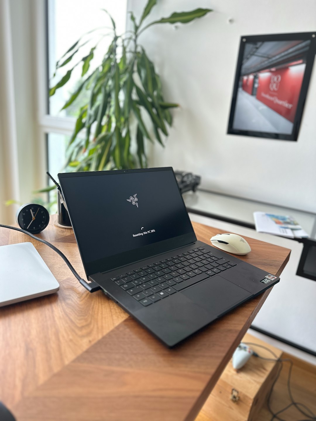 open-black-laptop-on-a-wooden-desk-with-plant-fdd1ifgl-mc